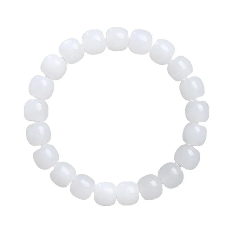 White Hetian jade barrel bead bracelet on a wrist, showing unisex casual style.