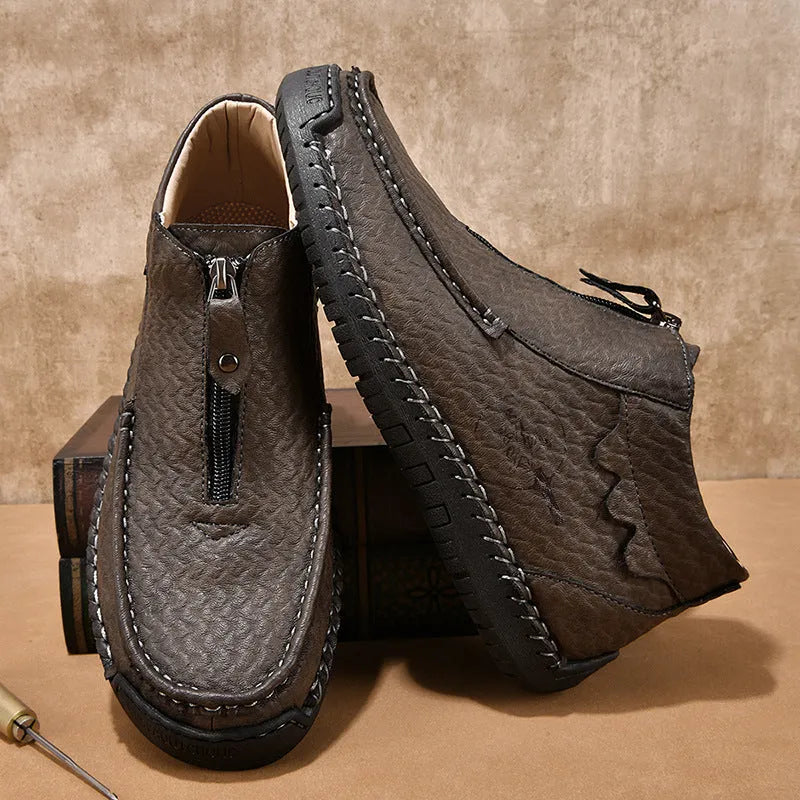 Men's black slip-on loafers with round toe and low heel design showing sewing detail on PU upper