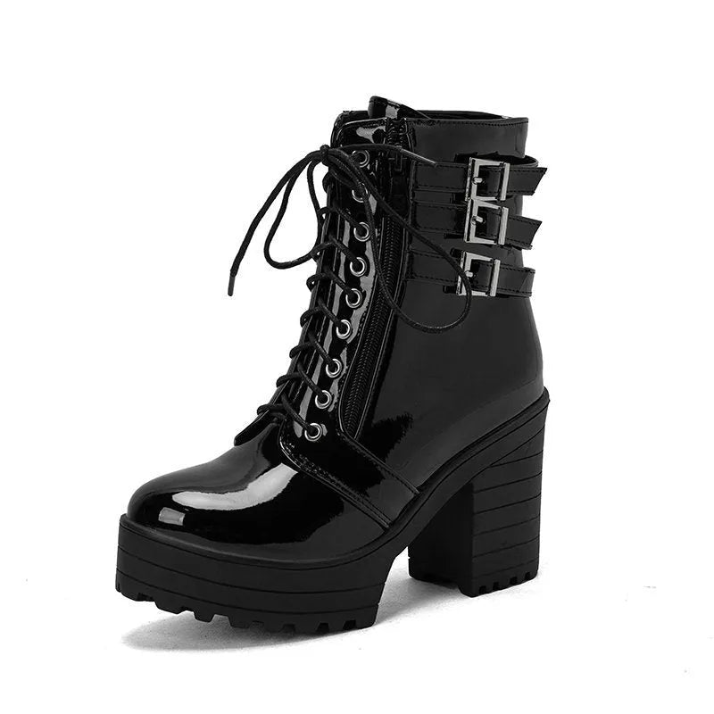 Women's black thick-heeled lace-up ankle boots with a round toe and rubber sole on a waterproof platform.