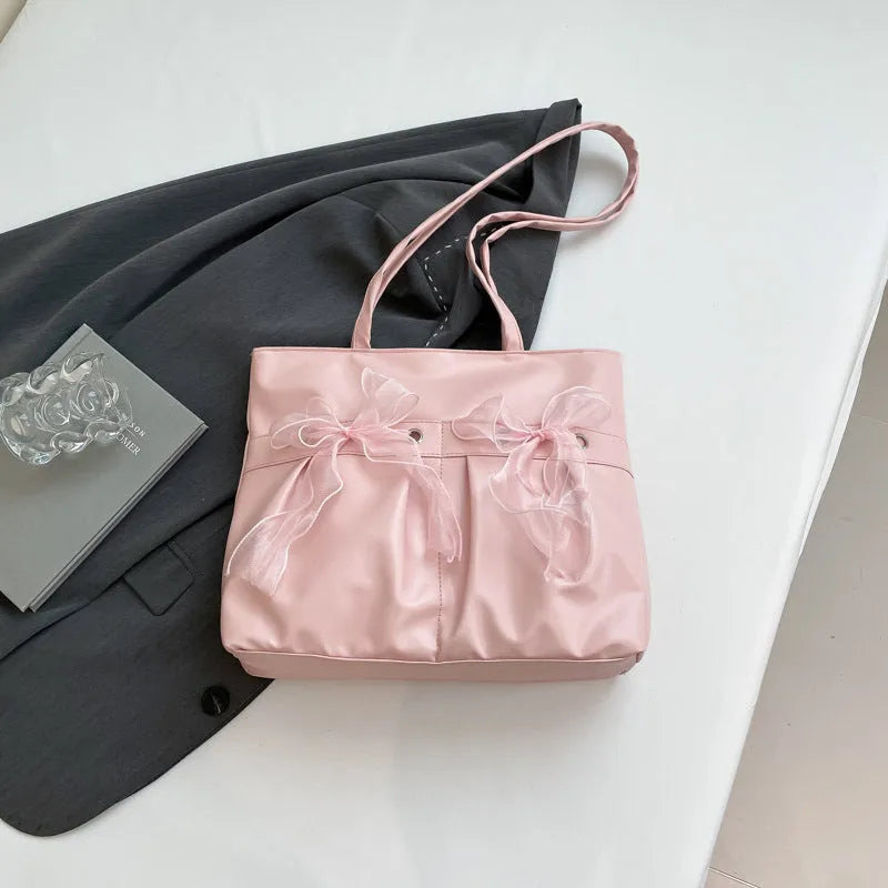 Black college-style bow tote bag with double shoulder straps and zippered compartment