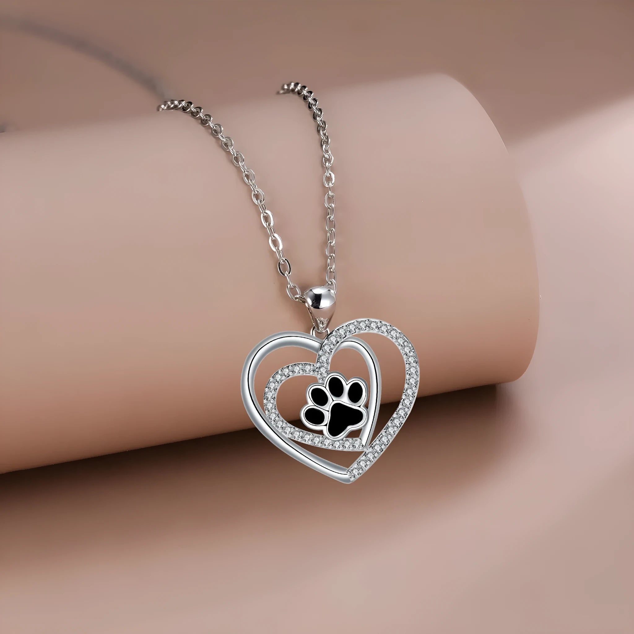 Women's copper necklace with dog's paw footprints and heart-shaped pendant on cross chain