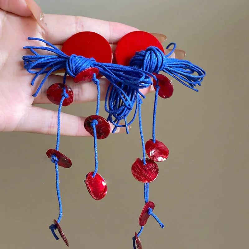 Women's geometric earrings with blue resin flowers on cloth material featuring silver needle elements