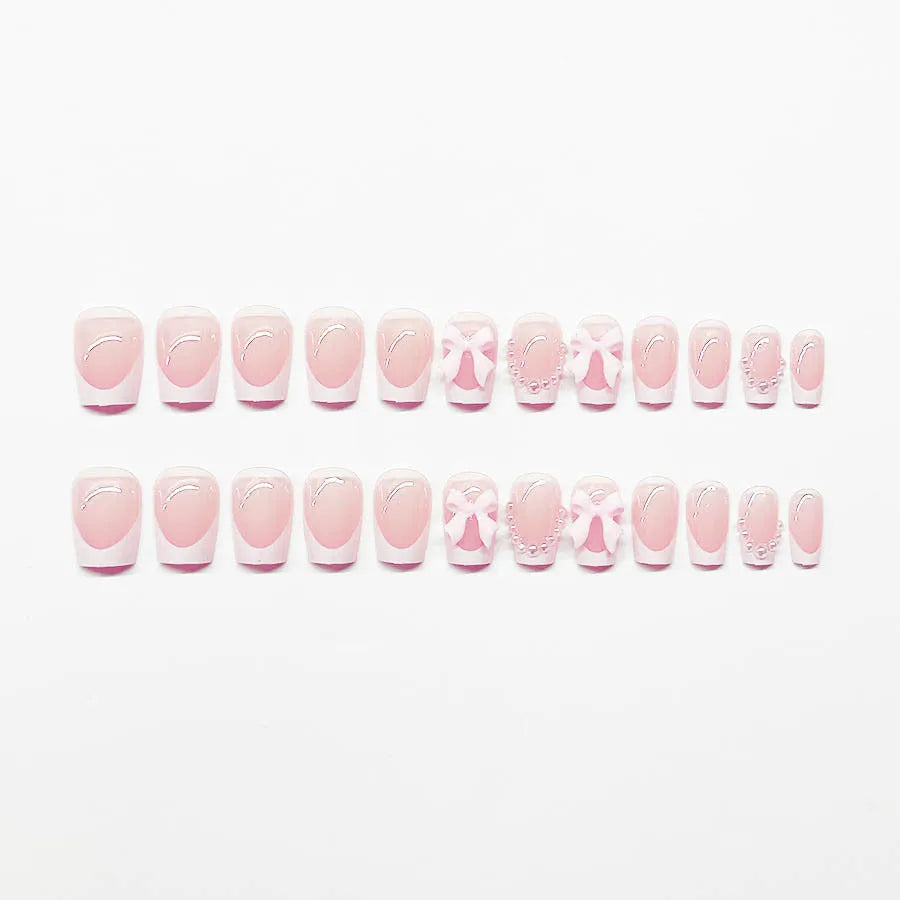 Short white French fake nails with cute bow and tulip patterns for ladies manicure