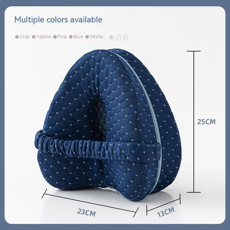 Love heart-shaped dark blue memory foam leg pillow for adults on a bed.