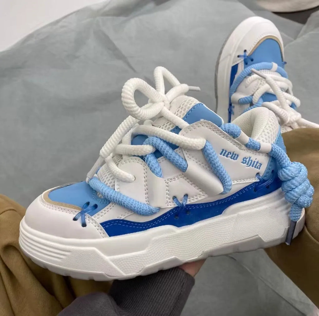 Women's grey retro chunky platform sneakers with thick rubber sole and lace-up front.