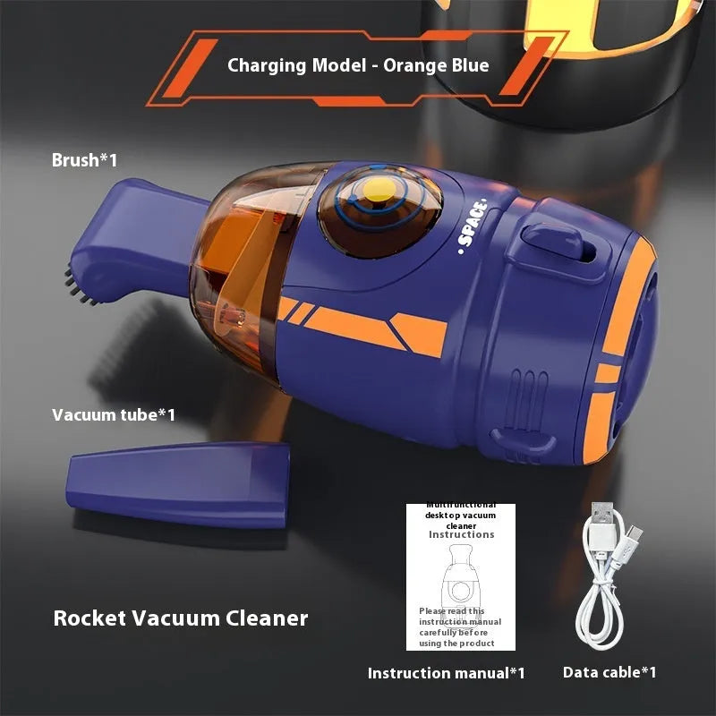 USB charging handheld desktop vacuum cleaner in blue rocket design on computer keyboard