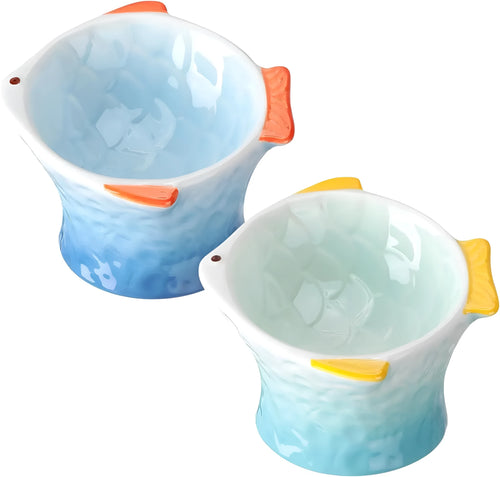 Four fish-shaped ceramic cat bowls in assorted colours with elevated design and tilted angle