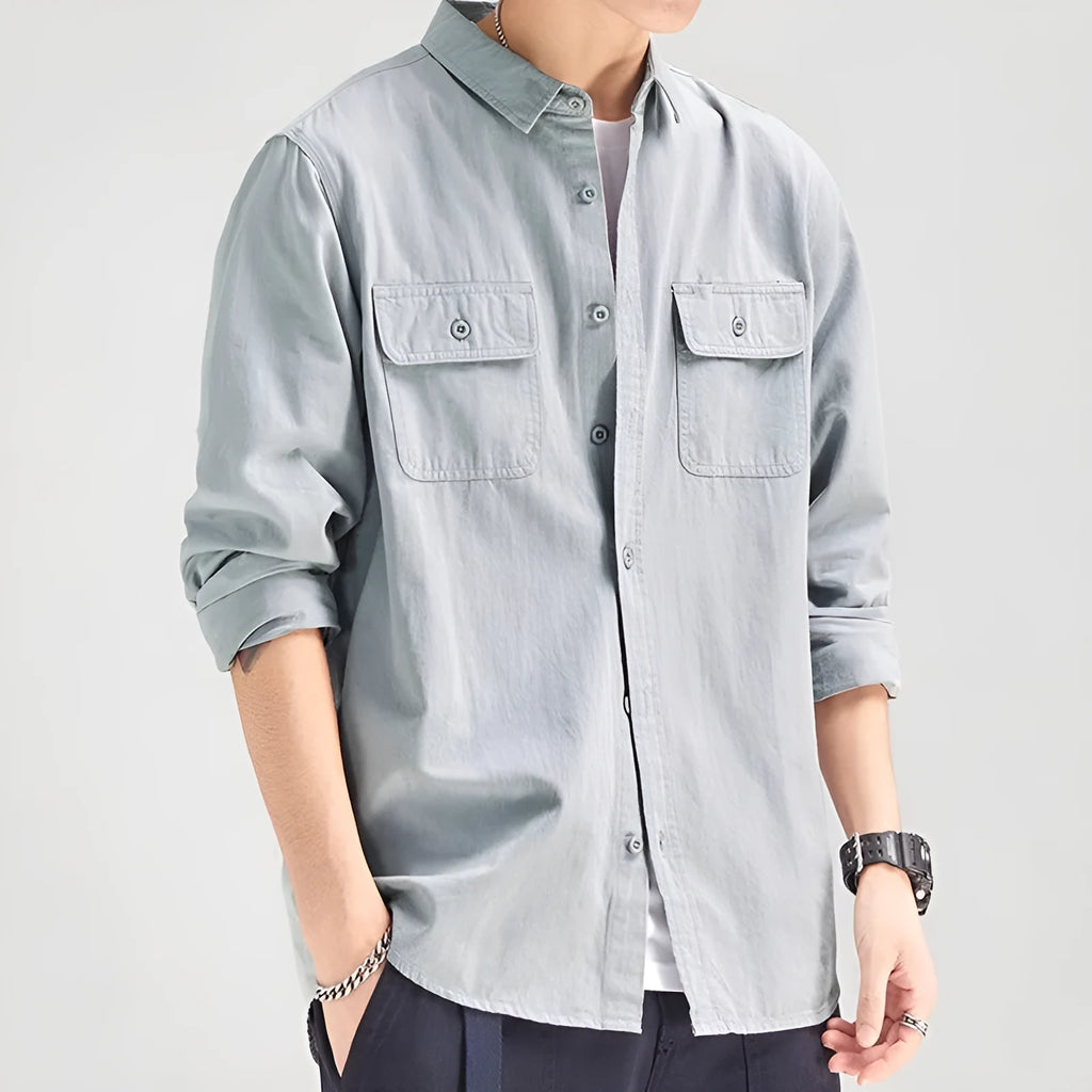 Man wearing a loose fit, long sleeve cardigan-style shirt overall in khaki polyester fabric.