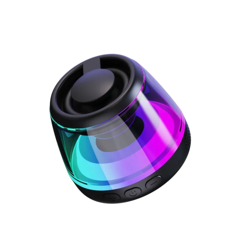 Black and white portable Bluetooth speaker with magnetic base and ambient lighting on desktop