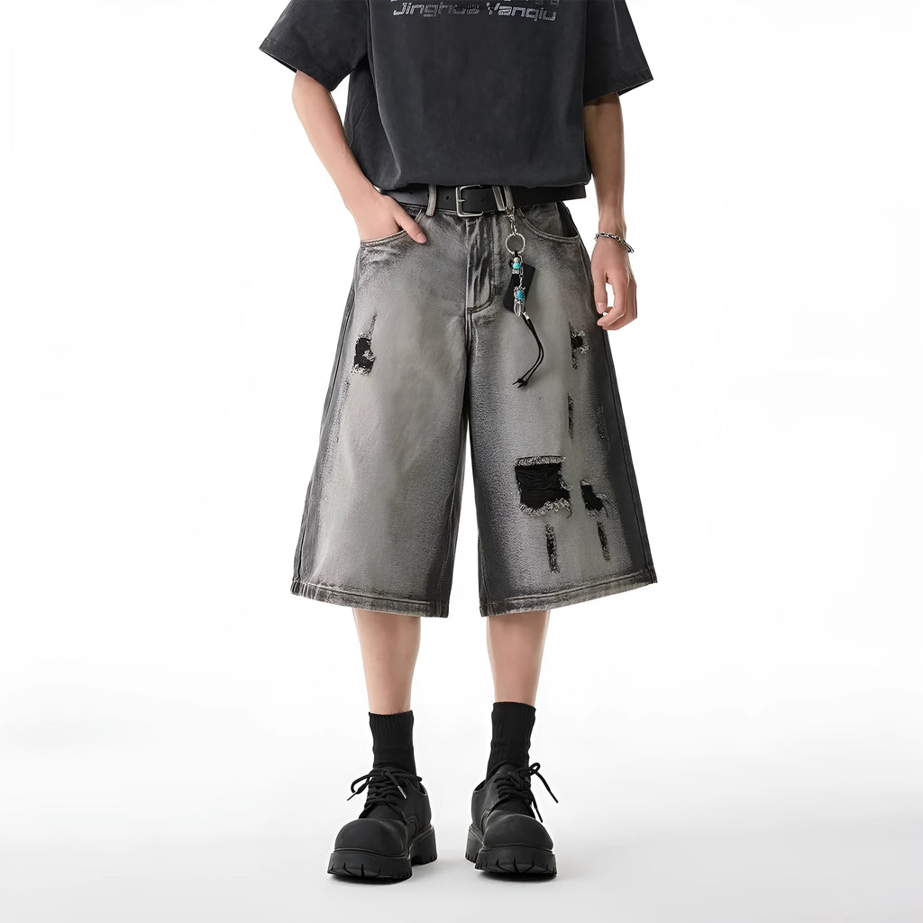 Grey loose-fit denim shorts with a water-washed finish and distressed hole details.