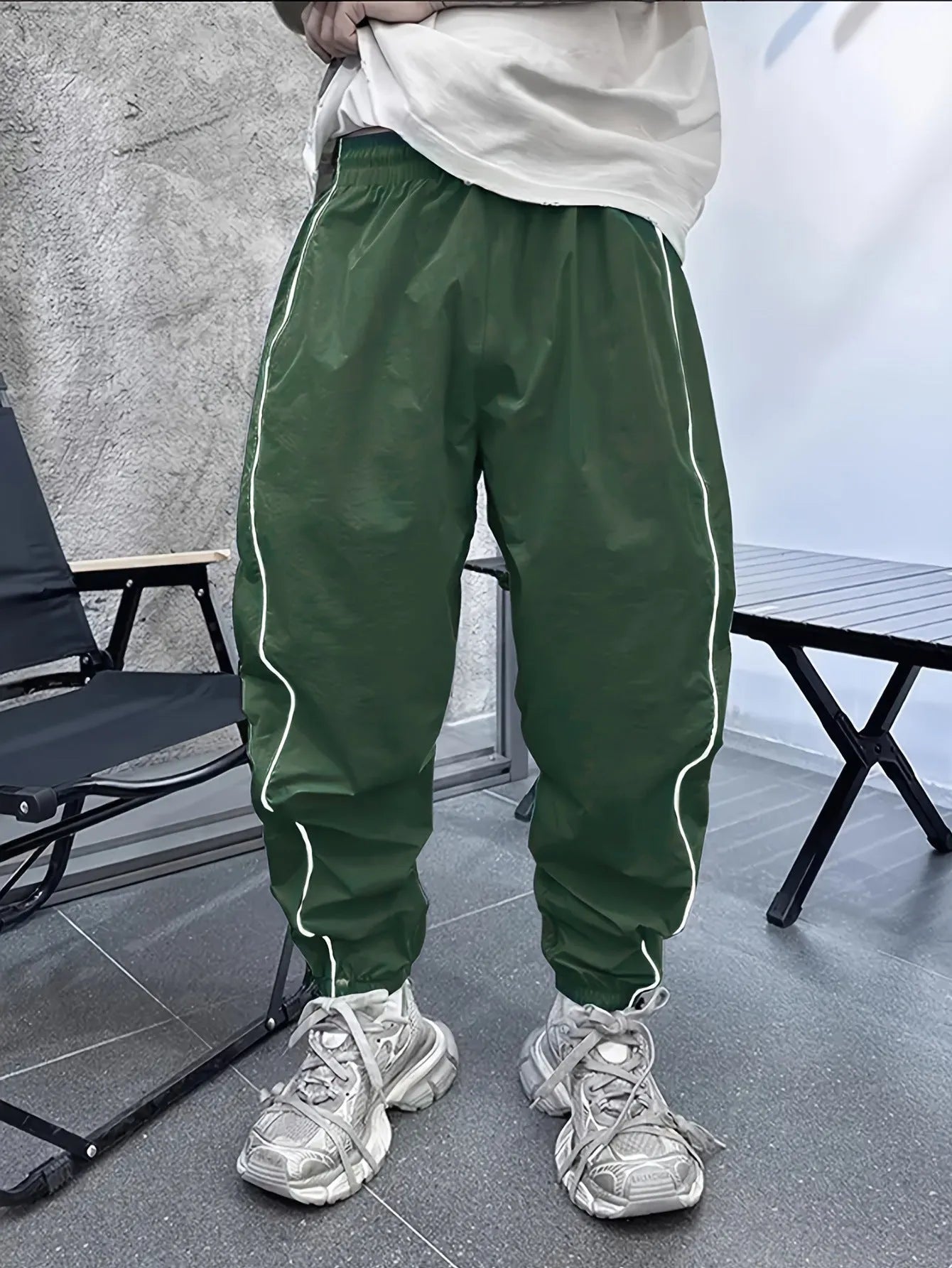 Man wearing blue bamboo fibre casual trousers with a cropped leg and loose fit.
