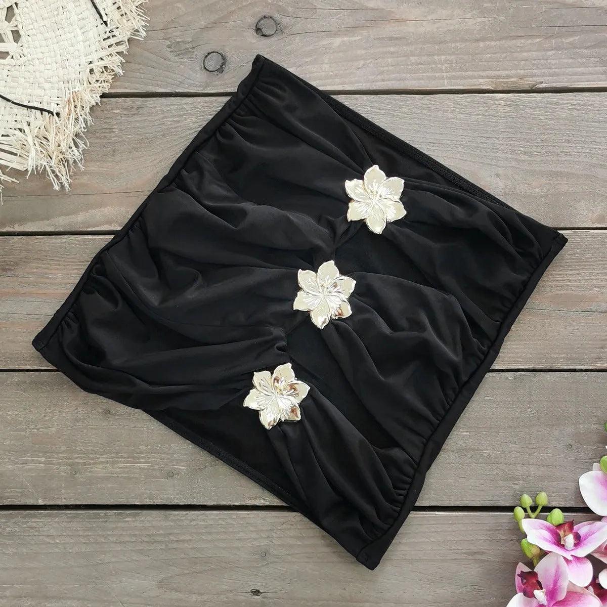 Women's black one-piece swimsuit with matching skirt and hollow-out tube top design