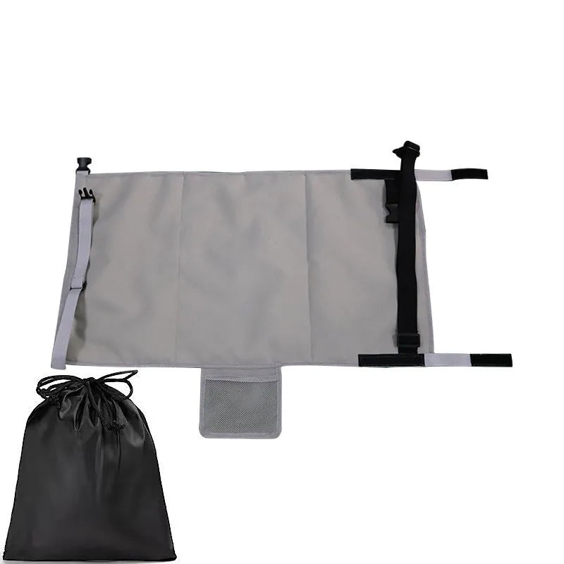 Portable grey nylon children's aircraft seat pedal extender with a matching drawstring pocket.