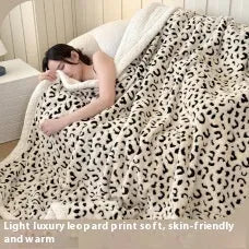 Double-layer Jacquard taffeta blanket with leopard print design in camel colour folded to show texture and pattern detail