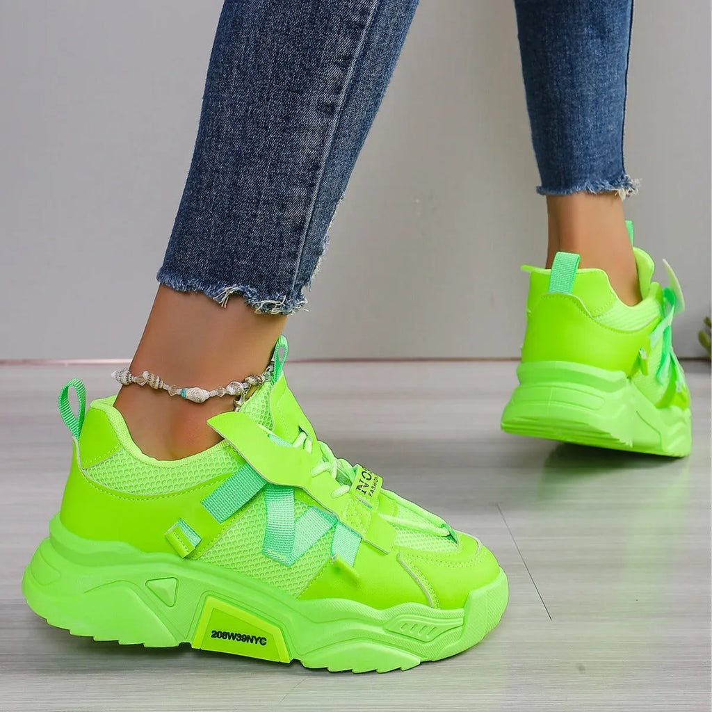Women's purple platform mesh sports shoe with lace-up front and thick sole for height increase.