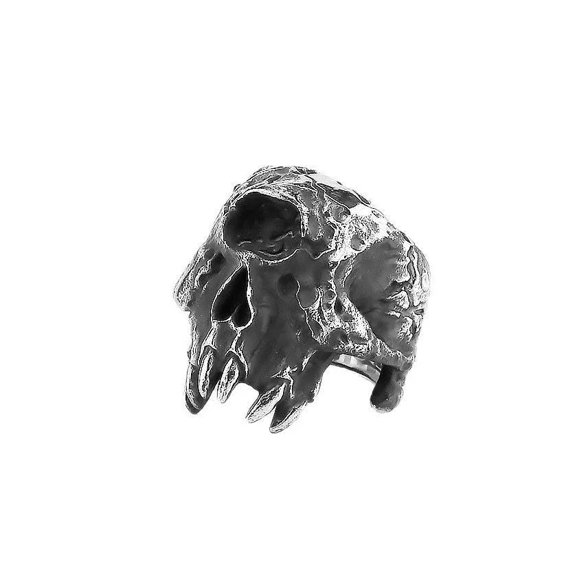 A close-up view of a silver-toned alloy ring featuring a detailed one-eyed skull design in a retro punk style.