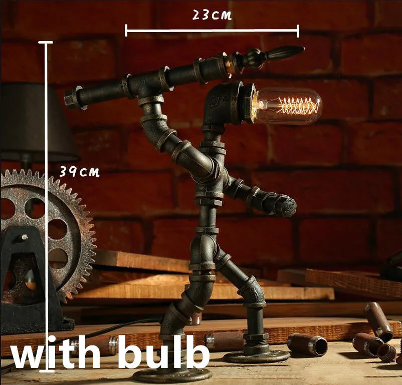 Green bronze vintage industrial robot desk lamp with iron pipe design on a wooden table.