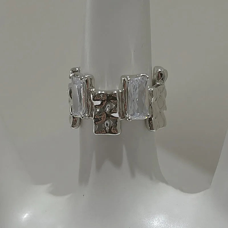 Silver geometric zircon cross ring with open centre and retro design