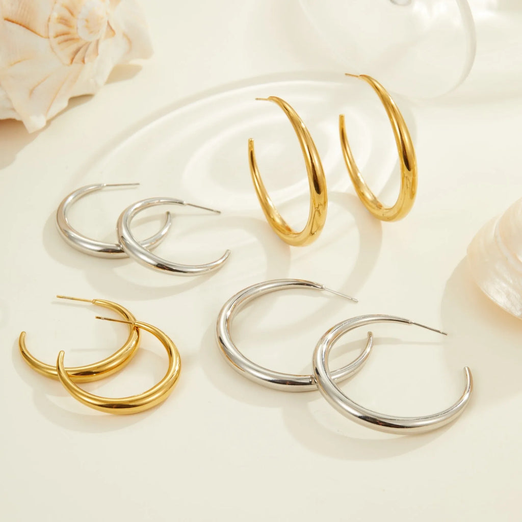 Titanium steel geometric hoop earrings with circular design and gold or steel finishes