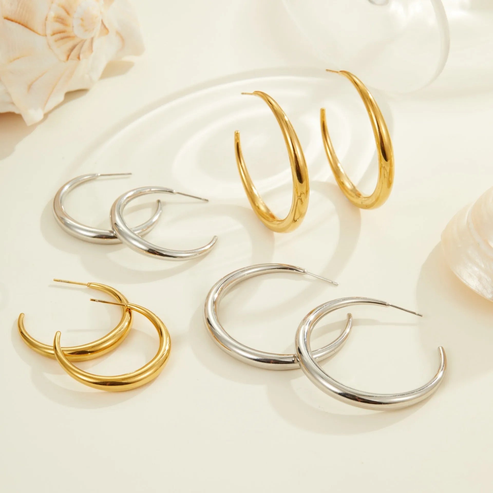 Titanium steel geometric hoop earrings with circular design and gold or steel finishes