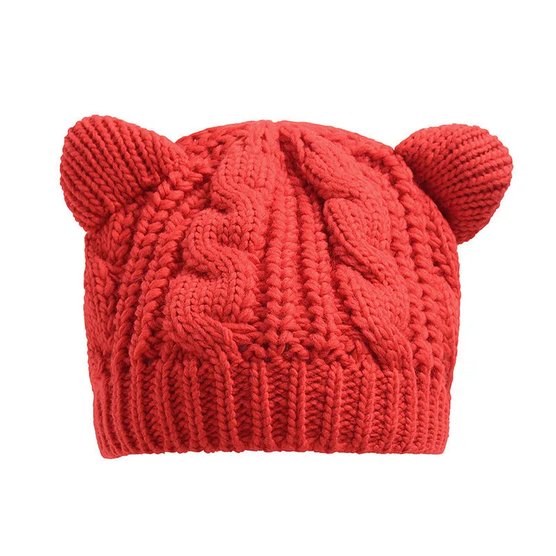 Hand-made chunky wool beanie with 3D knitted cat ears on a white background.