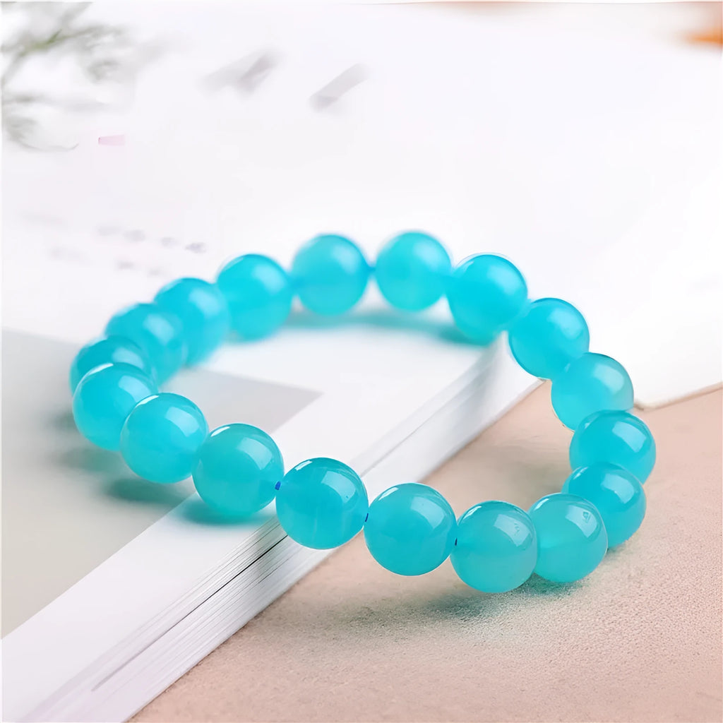 Natural blue-green amazonite scattered beads bracelet on wrist, showing polished stones and single circle design.