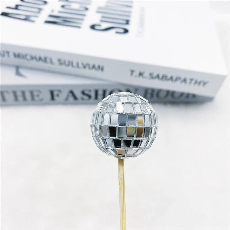 Glass disco ball cake decoration on a wooden stick, shown in different sizes for cake topping.