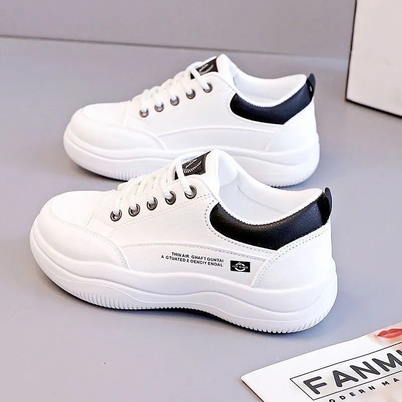 Women's white Korean-style low-top pumps with cross straps and round toe on a rubber sole.