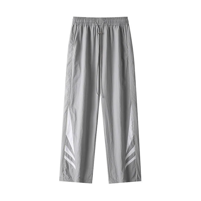Men's straight cut casual trousers in black with elastic waistband and cardigan button detail