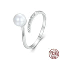 Women's adjustable sterling silver ring with natural pearl on open loop design