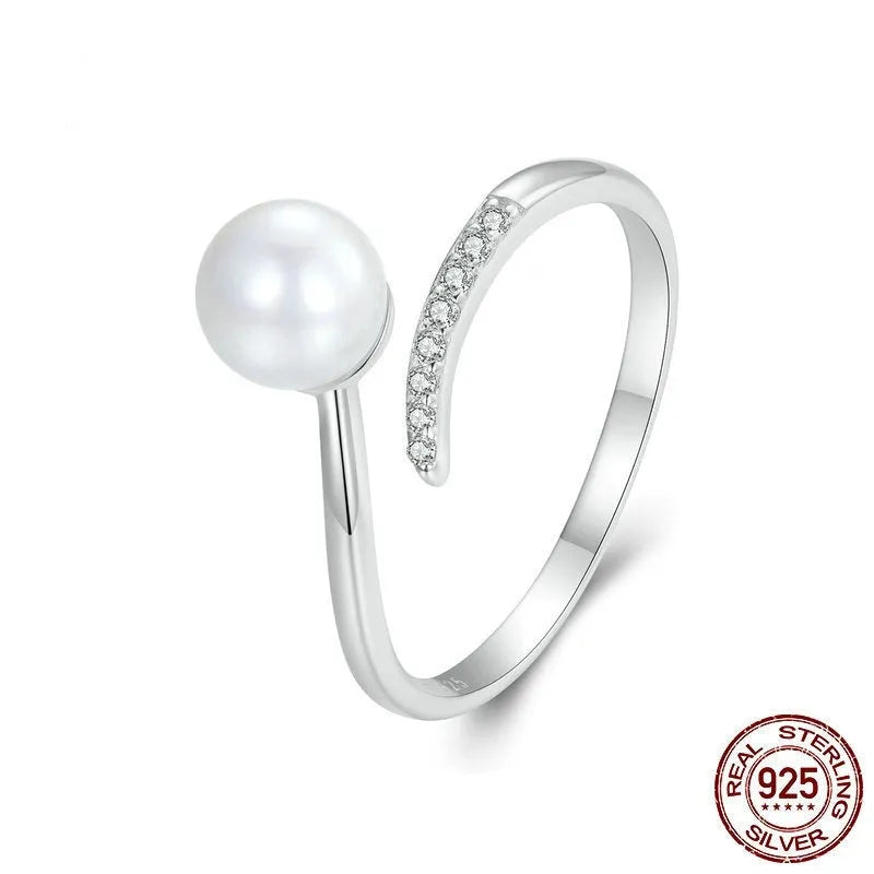 Women's adjustable sterling silver ring with natural pearl on open loop design