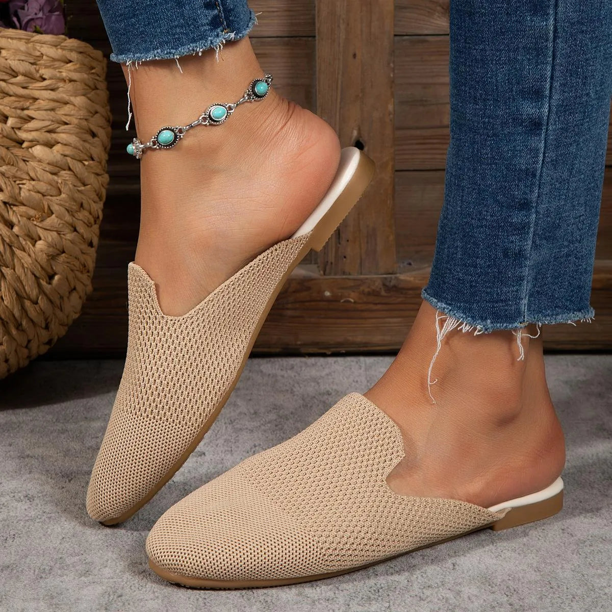 Apricot coloured mesh slip-on sandals with a round toe and flat rubber sole on a wooden floor.