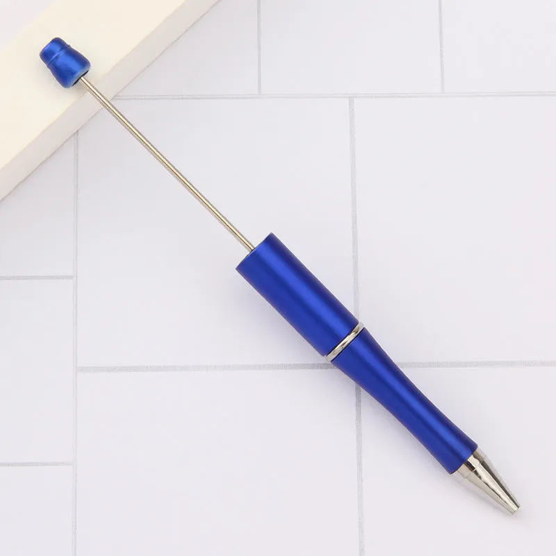 Creative ballpoint pen with multicoloured spinning plastic beads on a steel wire frame.