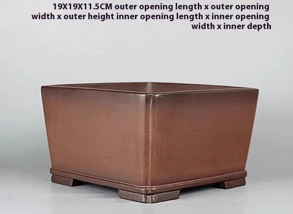 Brown antique classical style purple clay flower pot for plants on a windowsill.