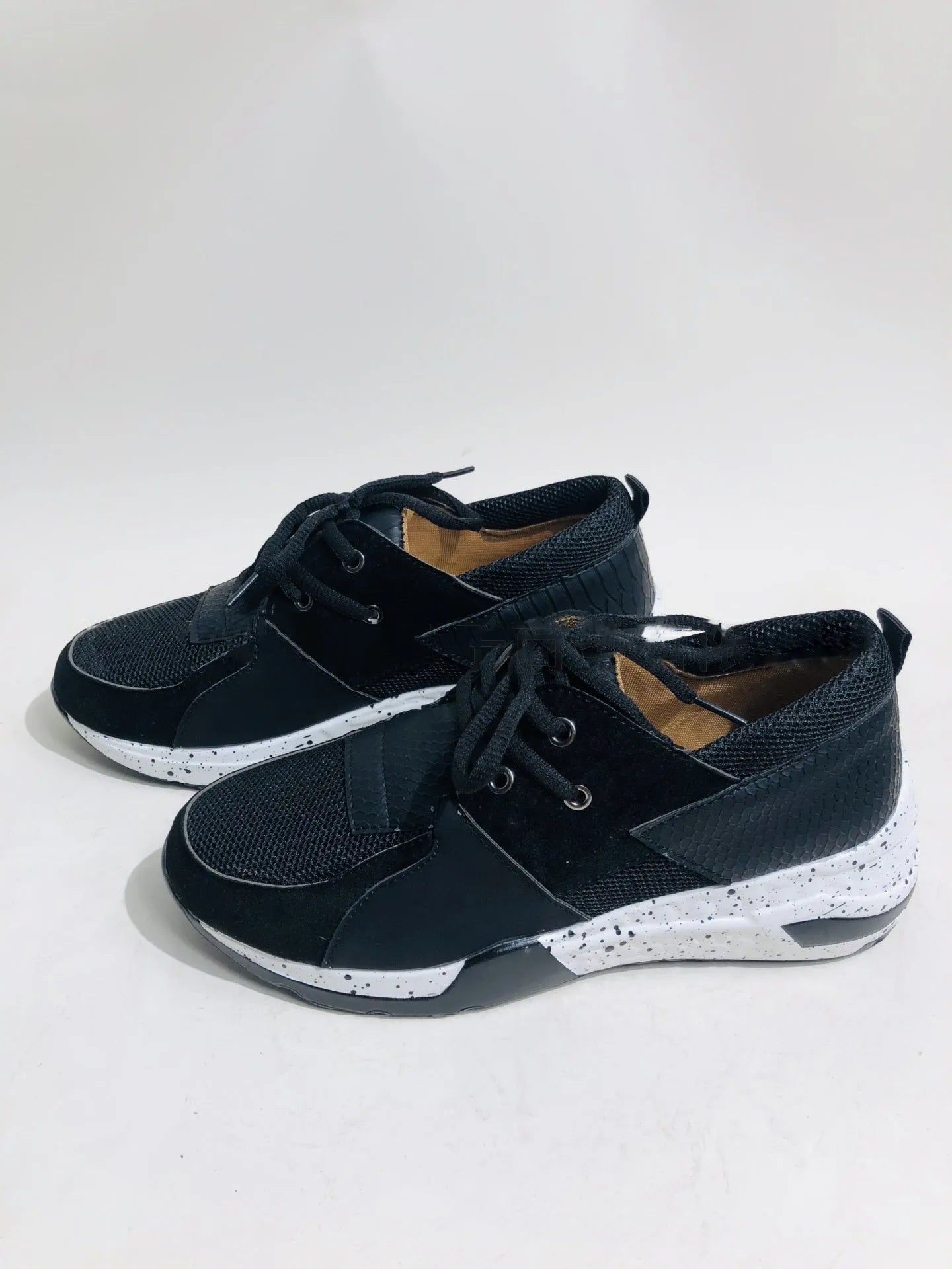 Women's casual suede sneakers with a wedge heel in various colours including black, pink, and leopard print.