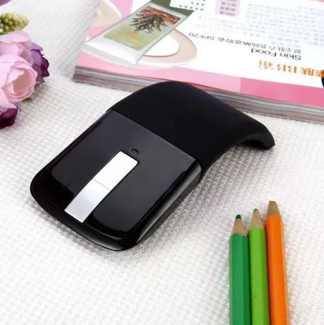 Folded black Bluetooth wireless mouse showing compact 131.2mm length and touch control surface