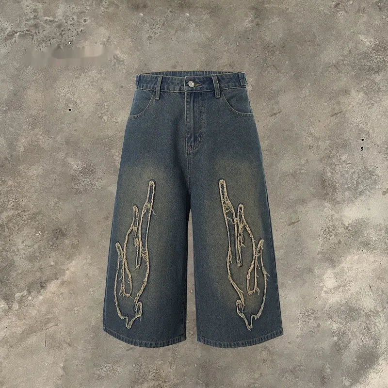 Men's black denim shorts with flame embroidery patch detailing, cropped length, straight leg cut