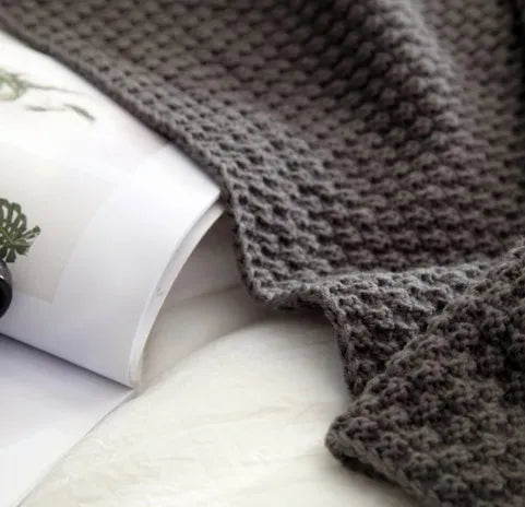 Nordic fringed knit ball acrylic blanket in beige colour, laid flat showing 130x170cm size and fringe detail