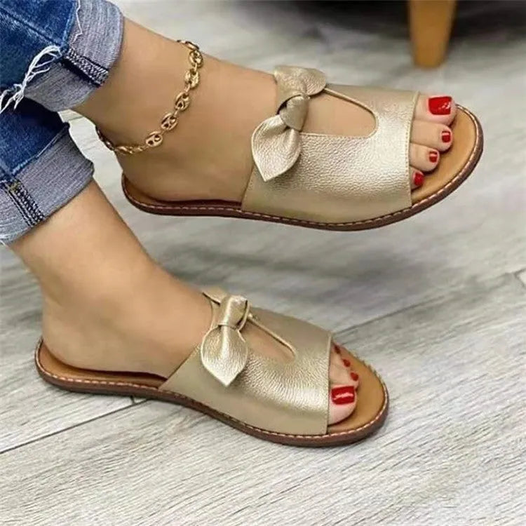 Ladies casual sandals with bow decoration and fish mouth toe opening in black, pink, and gold colours.