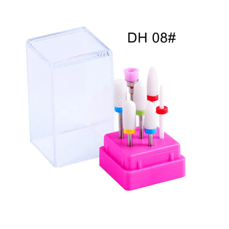 Set of seven tungsten steel nail drill bits and a brush in a transparent storage case.
