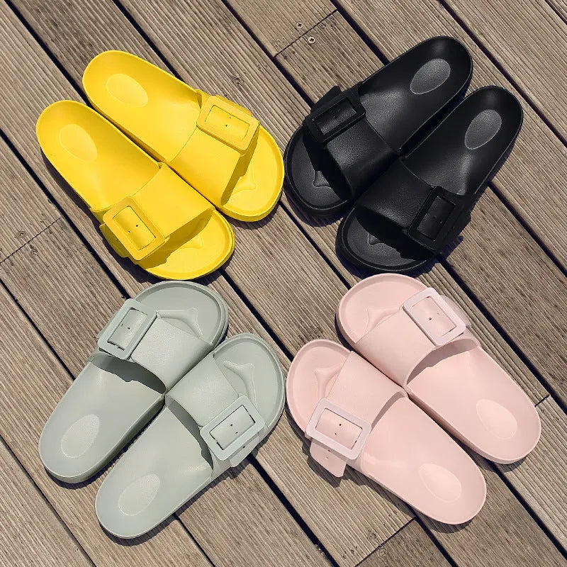 Women's grey blue EVA buckle slippers on a light background, showing the adjustable strap and textured sole.