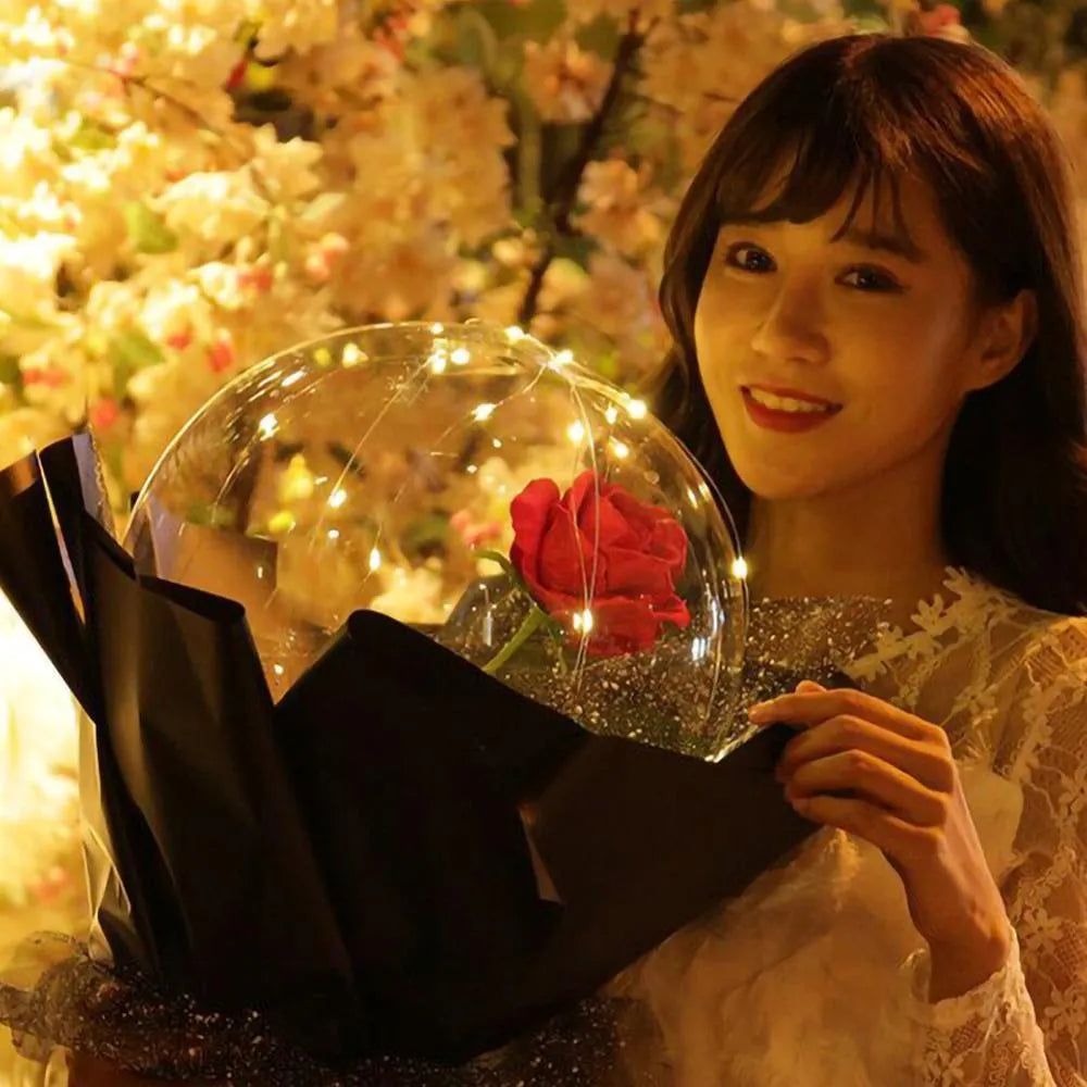 Transparent LED luminous balloon bouquet with artificial rose and glowing light inside, displayed as a DIY kit.