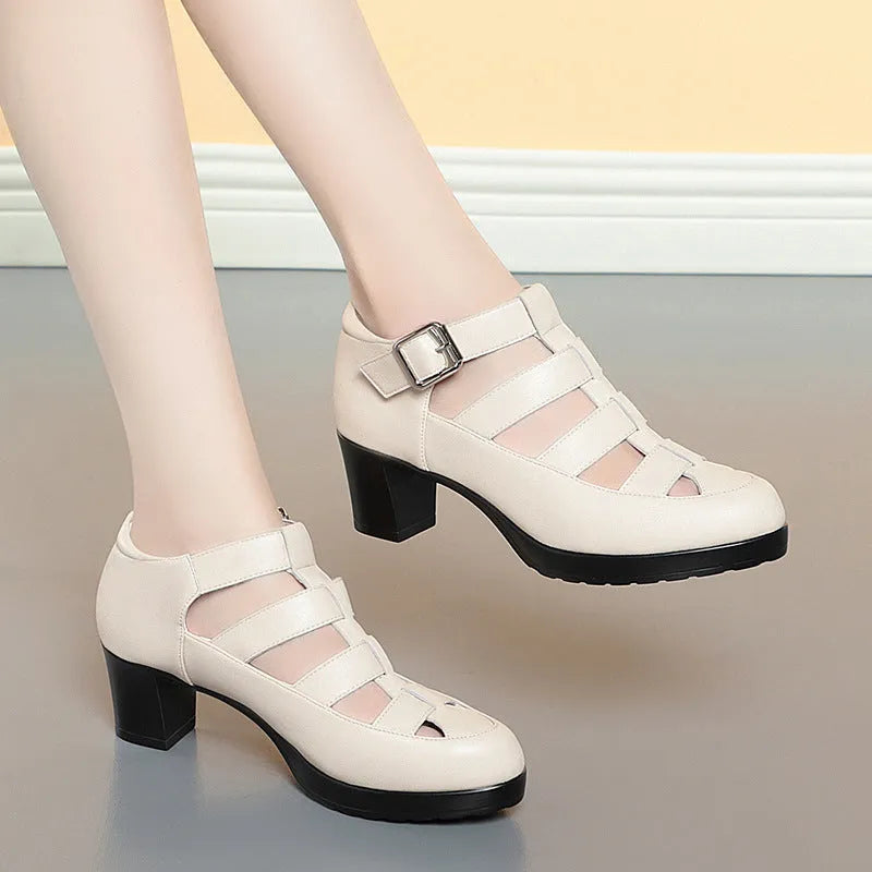 Women's beige closed toe sandals with a chunky heel, woven upper, ankle strap buckle, and back zipper.