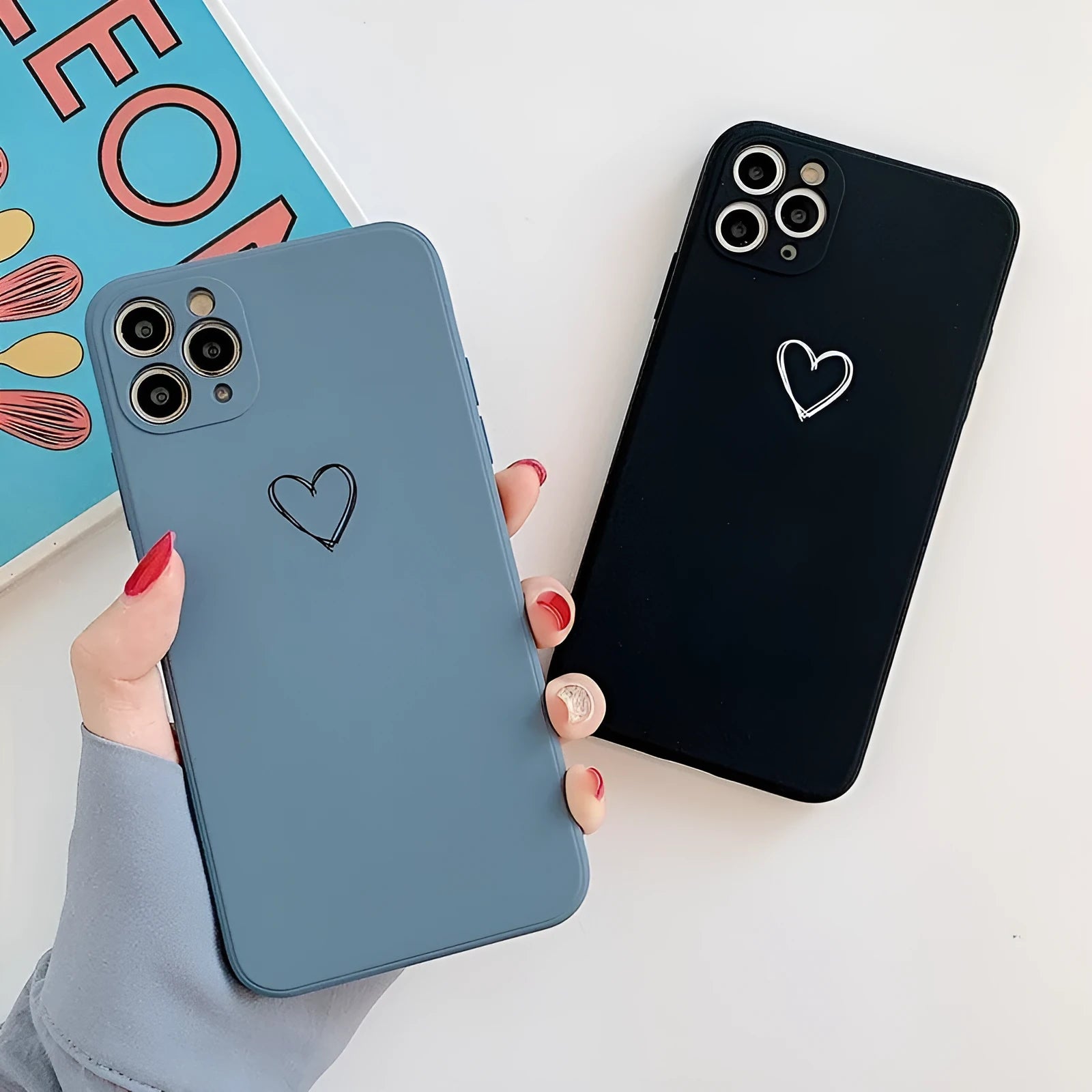 Silicone TPU back cover case for iPhone in solid colours like black, pink, and green on a white background.