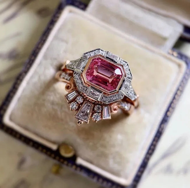 Women's retro style fashion ring with geometric design, rose gold finish and ruby detail