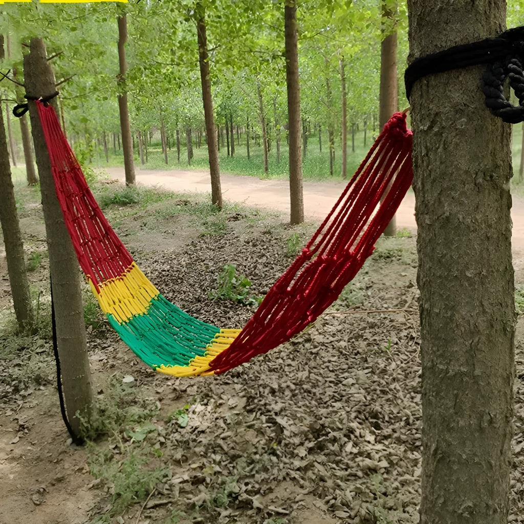 Outdoor nylon rope mesh hammock hanging between two trees, showing its woven construction and spacious 1.1m by 2.1m size.