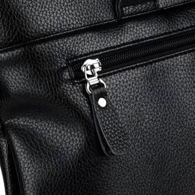Men's black PU leather messenger bag with crossbody strap showing splicing design detail
