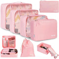 Set of eight cubic beige, black, pink, and green PP plastic travel packing cubes for organising underwear.