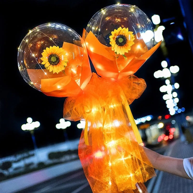 Transparent LED luminous balloon bouquet with artificial rose and glowing light inside, displayed as a DIY kit.