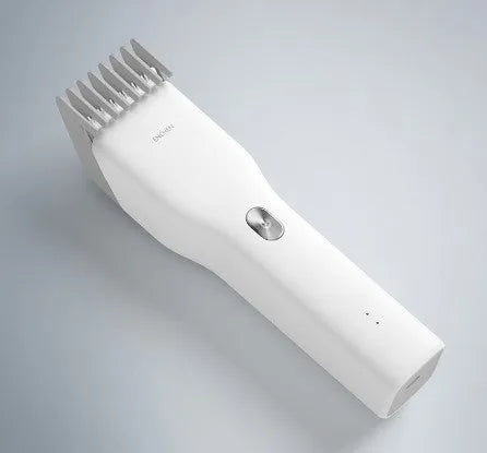 Black and white Boost model cordless hair clipper with adjustable comb on a stand